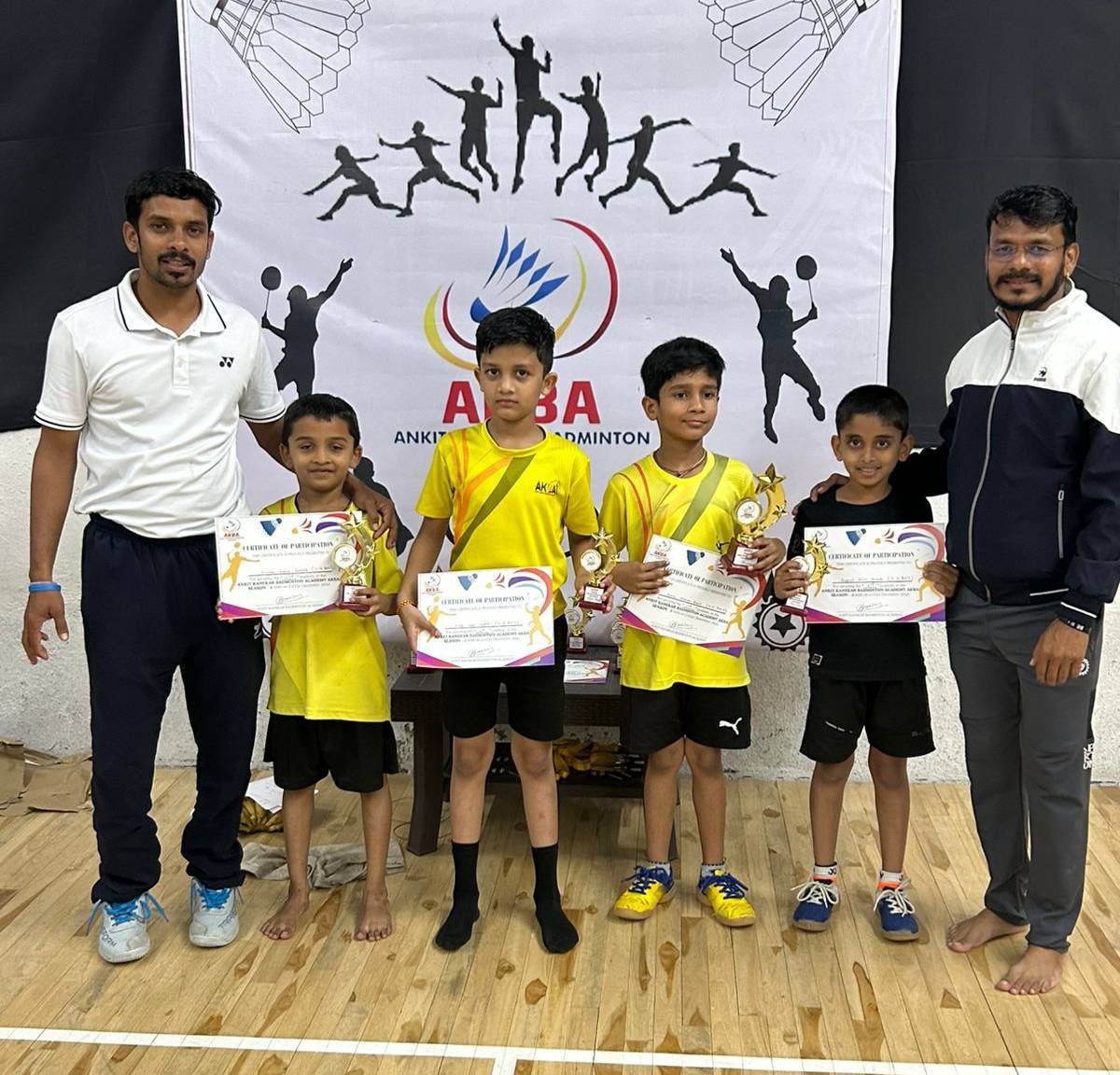 AKBA coaches with young players holding certificates and trophies