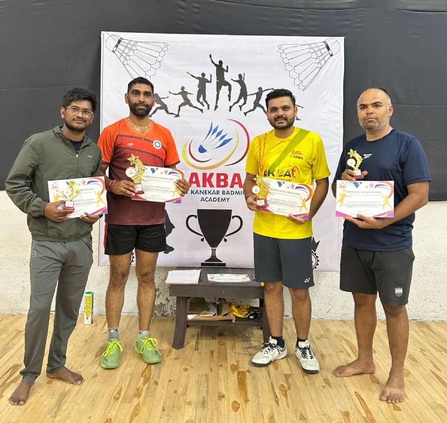 Players posing with certificates in front of the AKBA banner