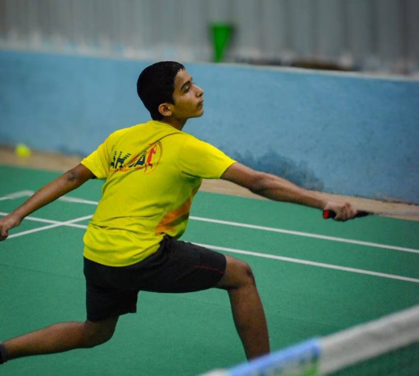 Player stretching for a backhand shot on court