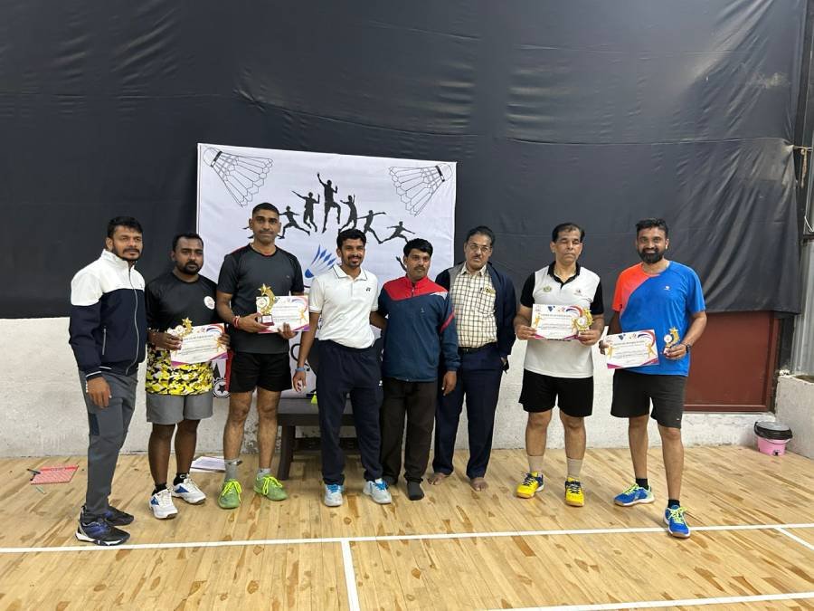 Group of players posing with medals and certificates